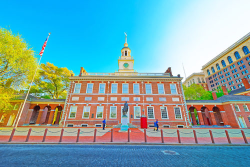 Independence Hall in Philadelphia Pennsylvania USA. It is the place where the US Constitution and the US Declaration of Independence were adopted. Tourists in the street
