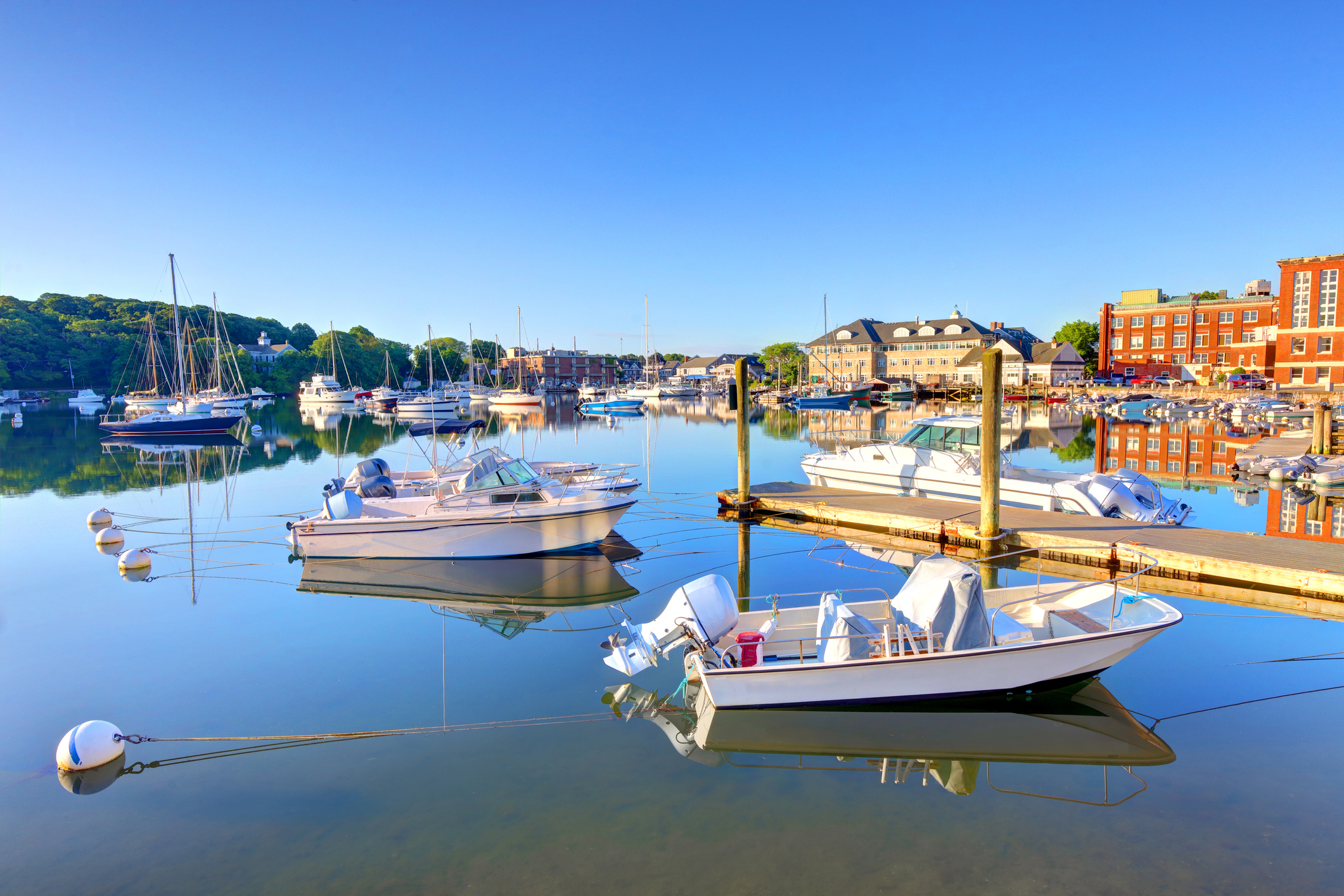 Boats docked in Woods Hole Harbor on a sunny morning in Massachusetts