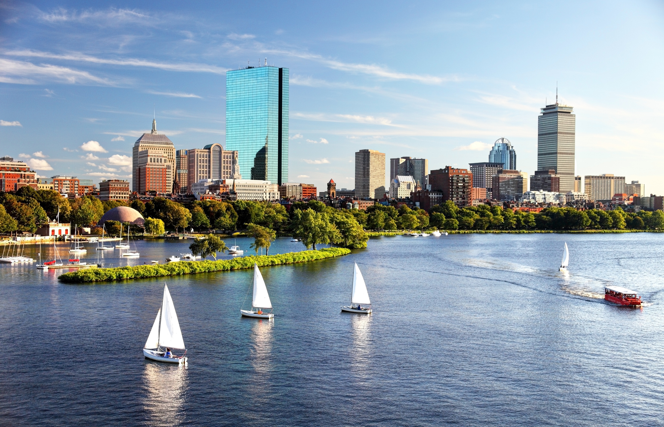 Boston skyline and waterfront with sailboats on a sunny afternoon