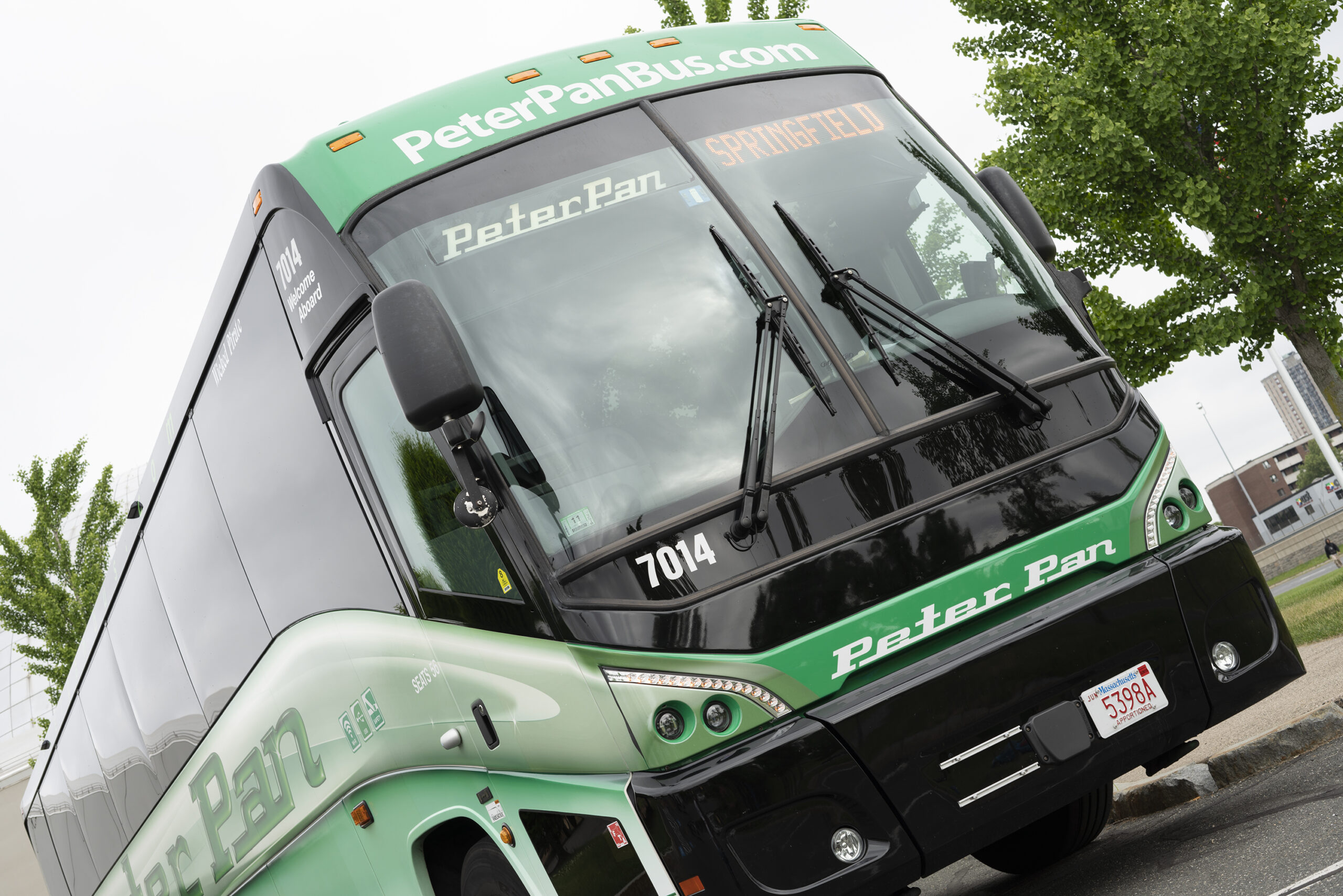 Front view of a Peter Pan Bus parked curbside, ready for departure—showcasing reliable, comfortable motorcoach service.