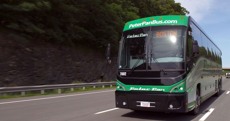 Peter Pan Bus traveling on the highway with Boston displayed as the destination on the front sign.