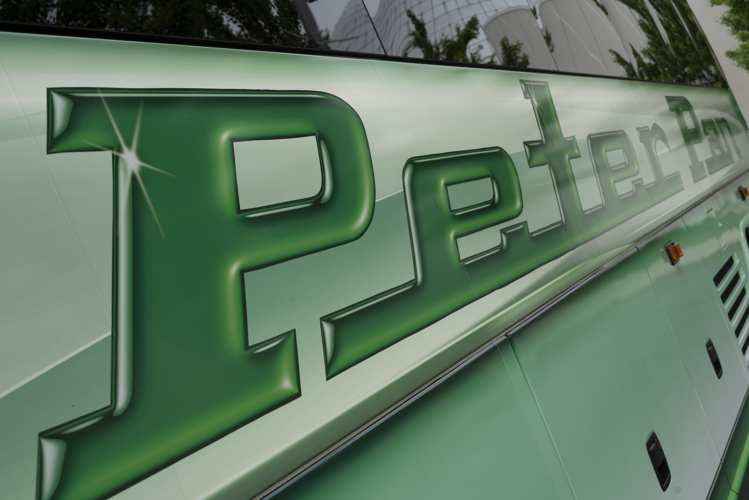 Close-up of the Peter Pan Bus logo on the side of a coach, representing affordable and reliable service from Worcester to New York City.