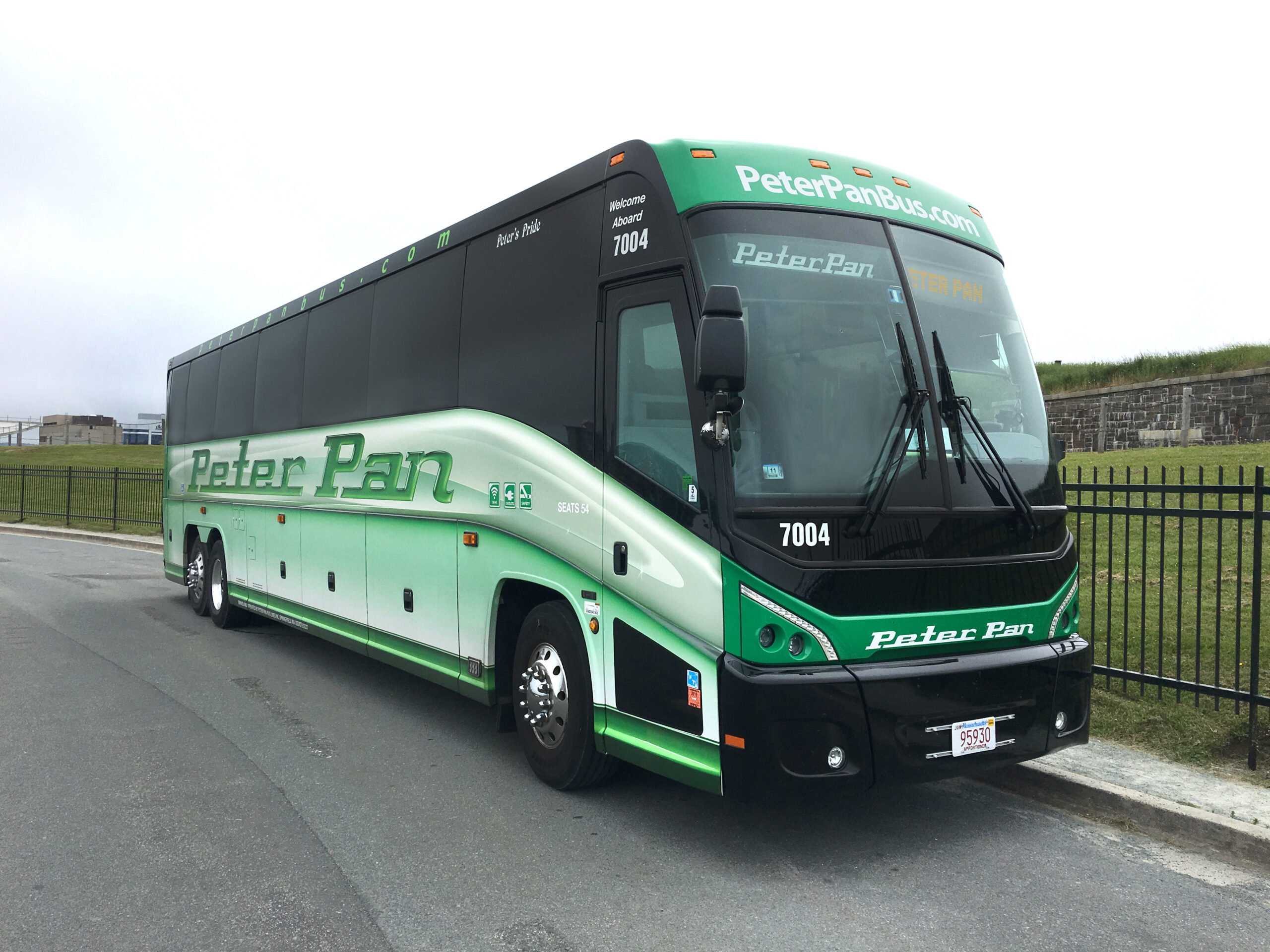 Peter Pan Bus #7004 parked in an outdoor location, representing service on the Philadelphia to Newark, NJ route—offering affordable, comfortable travel between two major cities.