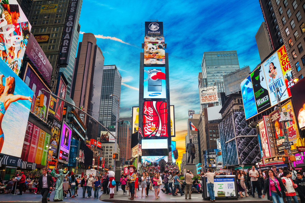 Crowds and bright billboards in Times Square, one of New York City’s most iconic destinations and a must-see stop when traveling by bus from Philadelphia.